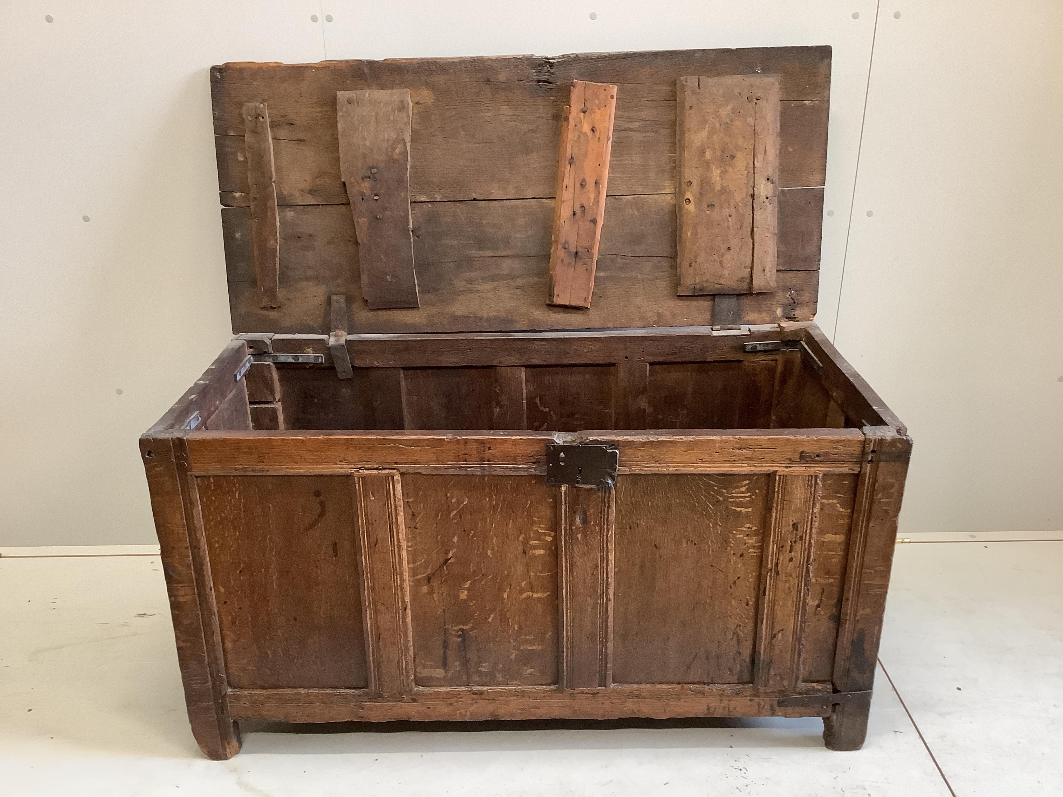 A late 17th century oak coffer with panelled front, width 135cm, depth 59cm, height 72cm. Condition - poor to fair